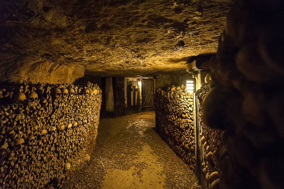 Dark tunnel of the Parisian catacombs.