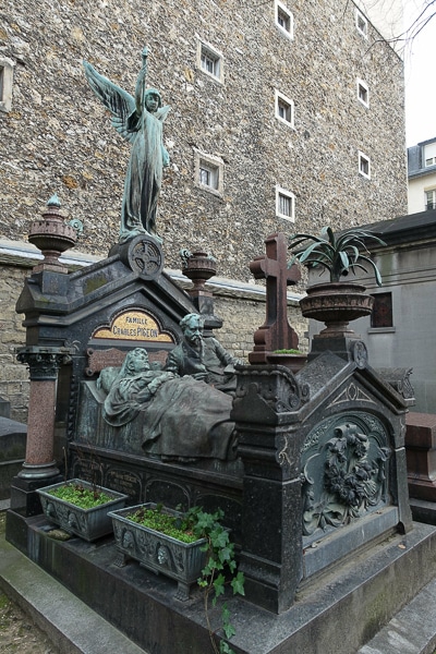 The bed-shaped tomb of Charles Pigeon, one of the most unique graves in Montparnasse Cemetery.