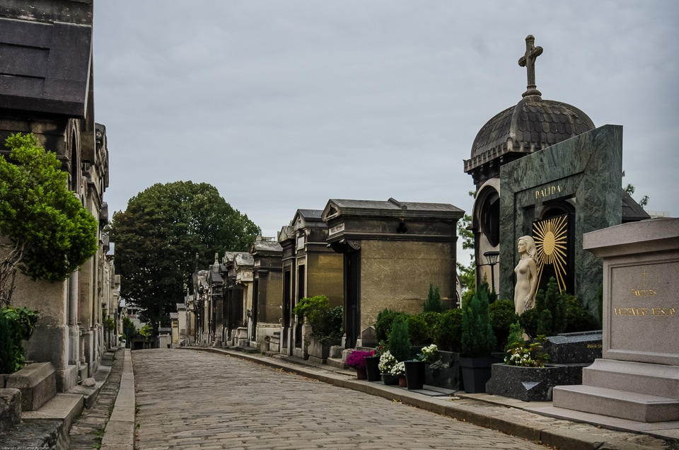 Cobblestone path and tombs in Montmartre Cemetery.