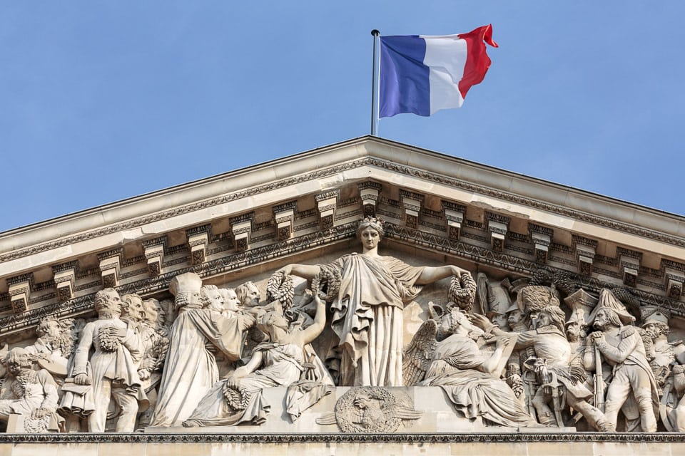 France flag flying above the pediment of the Pantheon.