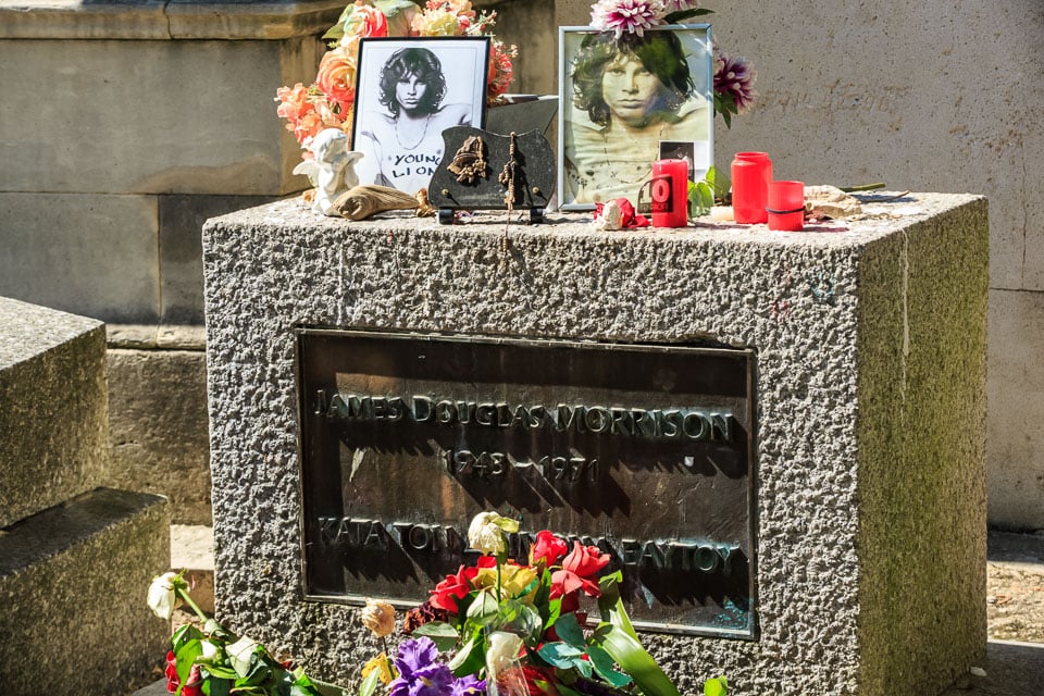 Photos and flowers left at the grave of Jim Morrison, one of the most famous graves in Paris.
