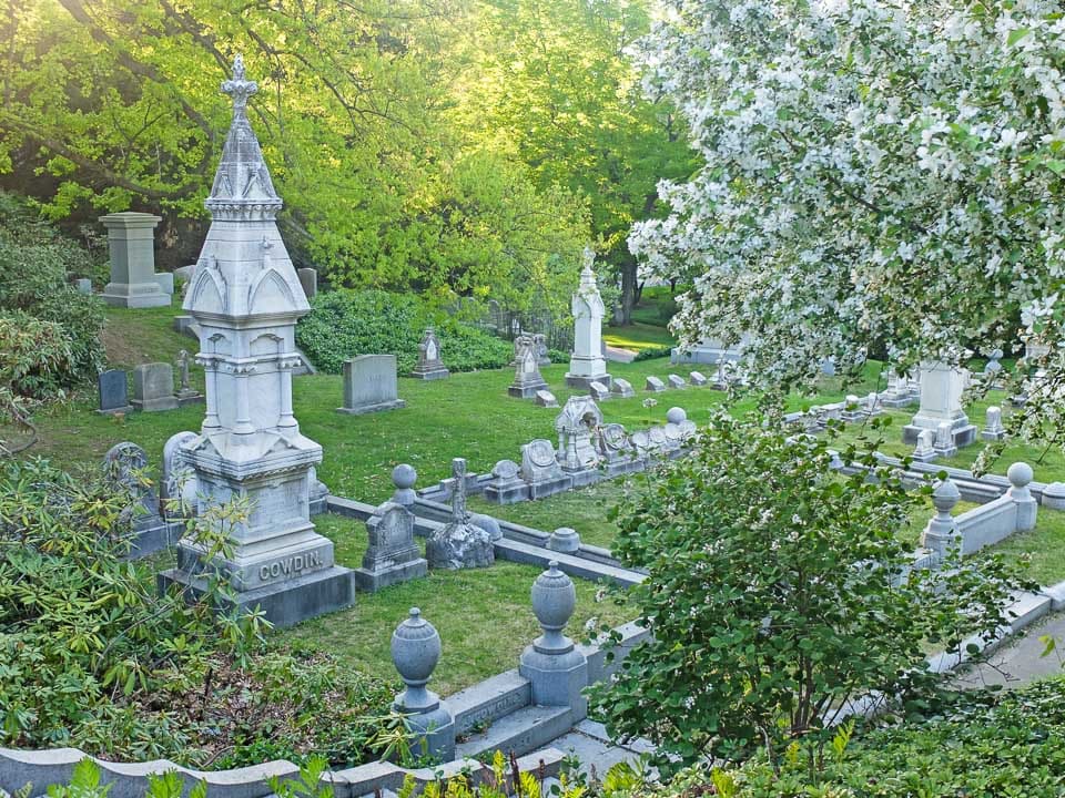 Funerary sculpture and tombstones mark the burials in Mount Auburn Cemetery.