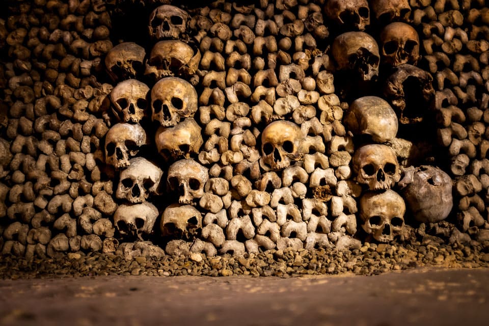 Stacked skulls and bones in the Parisian catacombs.