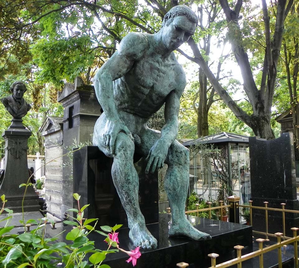 Large sculpture of a sitting man on Jean Bauchet's grave.