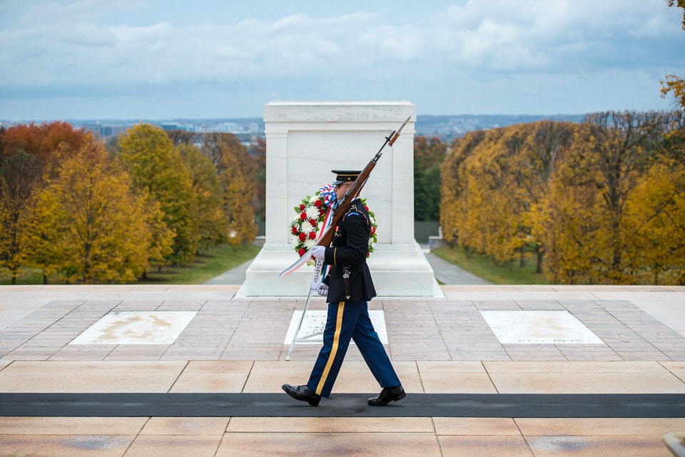 Soldier walking in front of the Tomb of the Unknown Soldier.