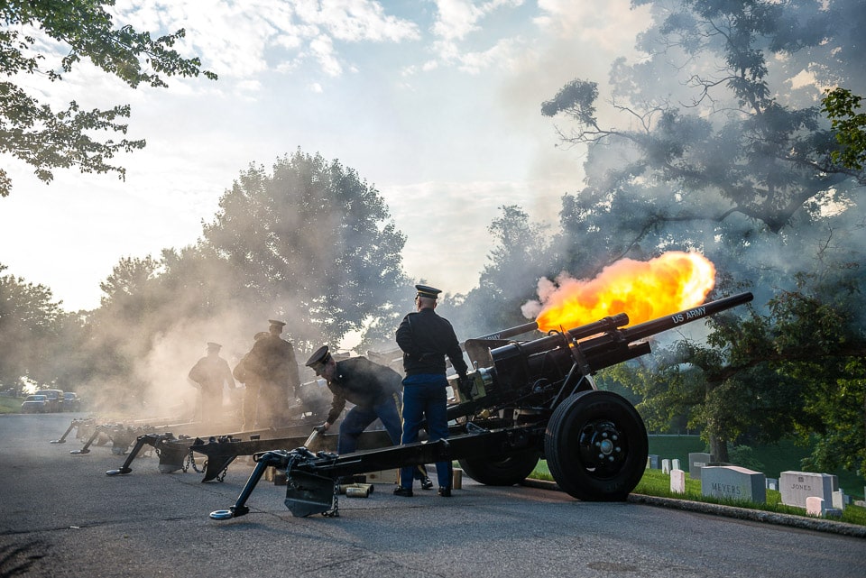 Soldiers firing cannons in the cemetery.