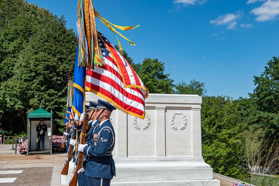 Soldiers holding flags during a ceremony at the tomb.