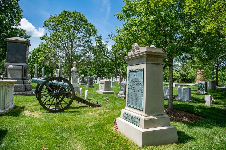 Variety of tombstone designs, including an old cannon, in Section 1 of Arlington National Cemetery.
