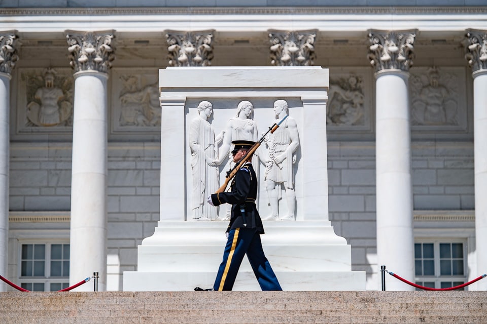 Soldier walking in front of the Tomb of the Unknown Soldier in Arlington National Cemetery. 