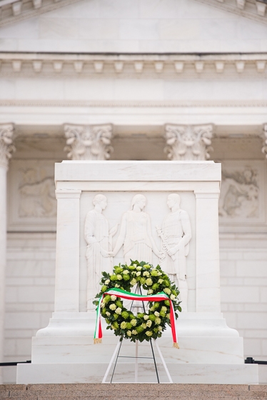 Wreath of white roses in front of the tomb.