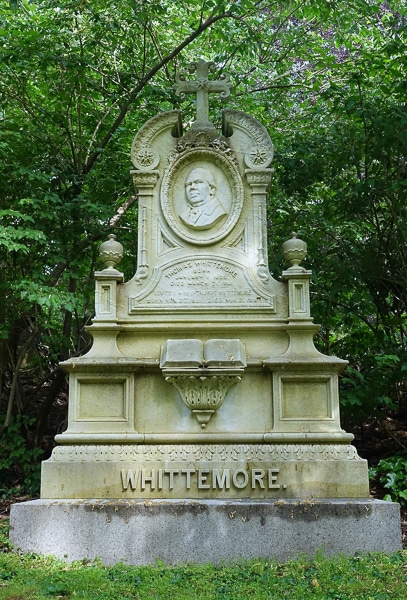 Whittemore memorial with a portrait relief carving.