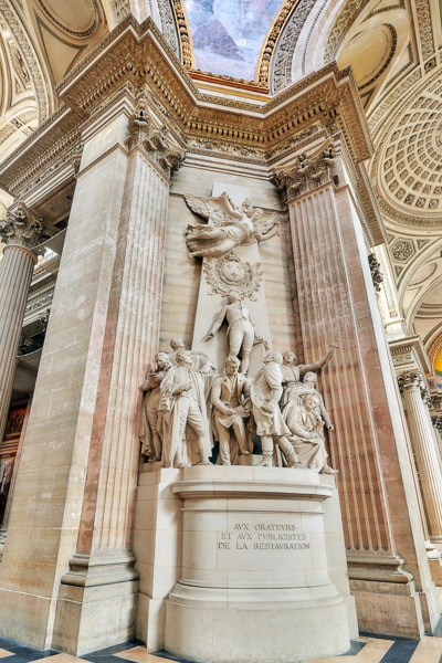 A sculpture framed by columns inside the Pantheon.