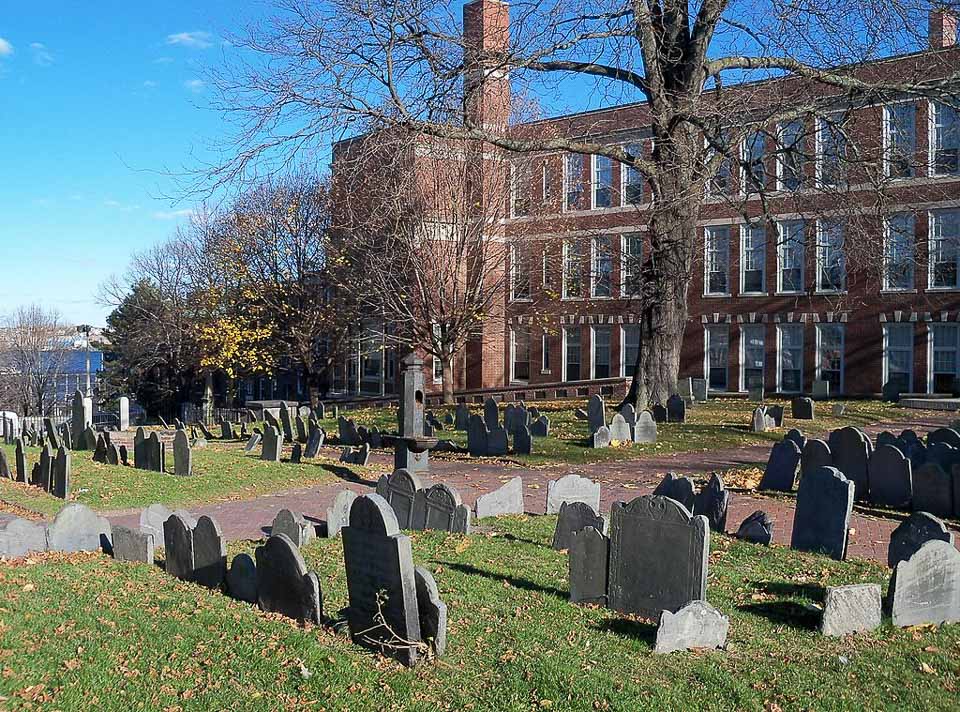 Copp's Hill Buying Ground with a brick building in the background.