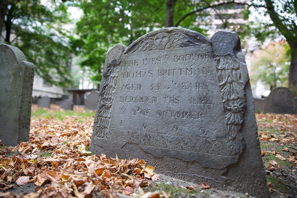 Tombstone and fallen leaves.