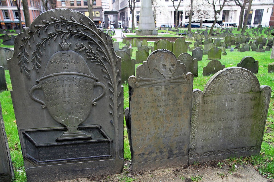 Three tombstones decorated with carvings.