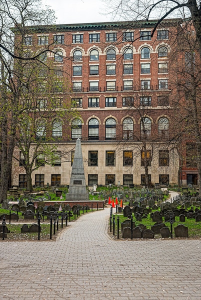 Sidewalk leading towards an obelisk in the cemetery.