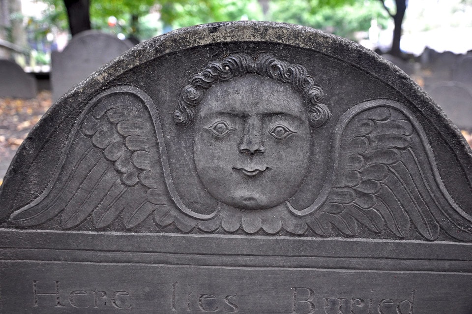 Face with wings on a tombstone.
