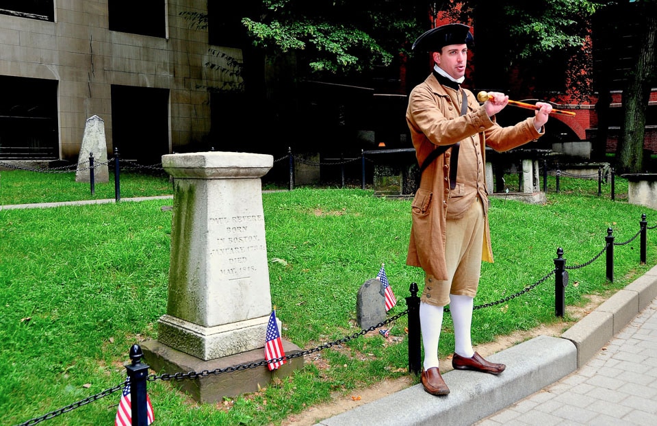 Tour guide in historical costume at Paul Revere's grave.