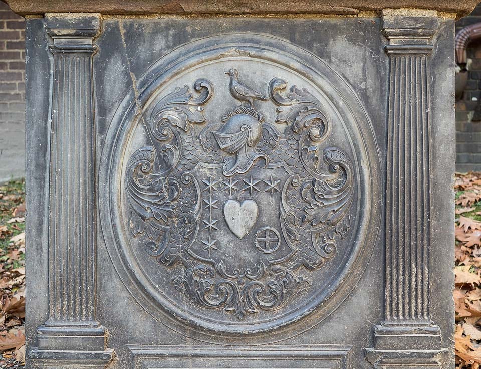 Knight helmet and shield design carved onto the tomb of Peter Faneuil.