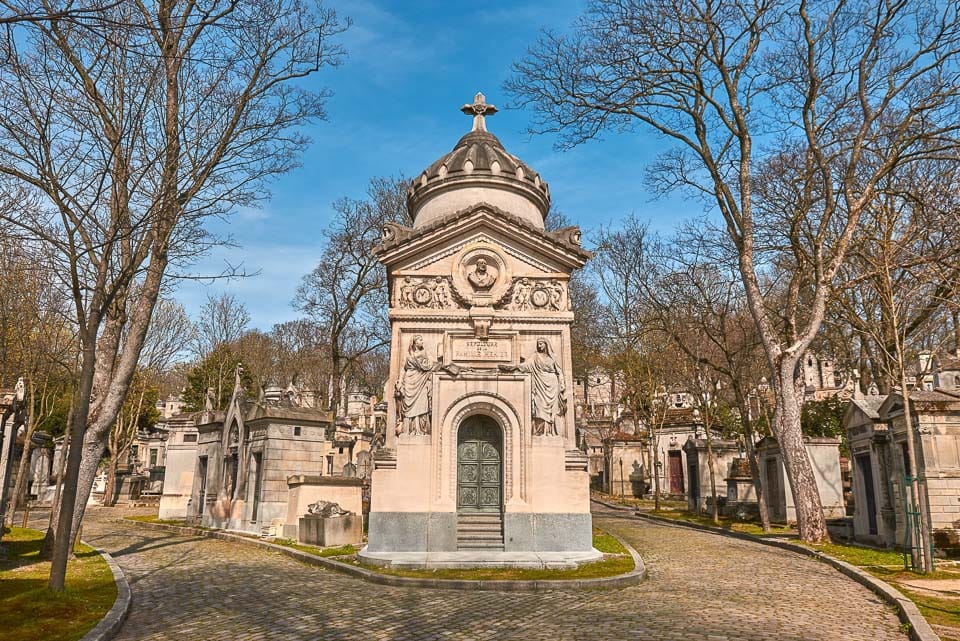 Mausoleums along two cobblestone paths in Pere Lachaise Cemetery, the most famous of Paris' cemeteries.