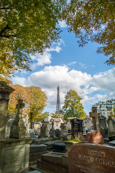 Tombstones with the Eiffel Tower in the background.