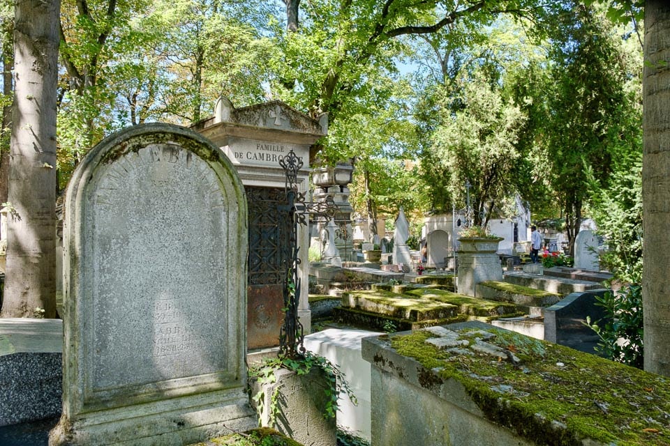 Tree-shaded gravesites in a Paris cemetery.