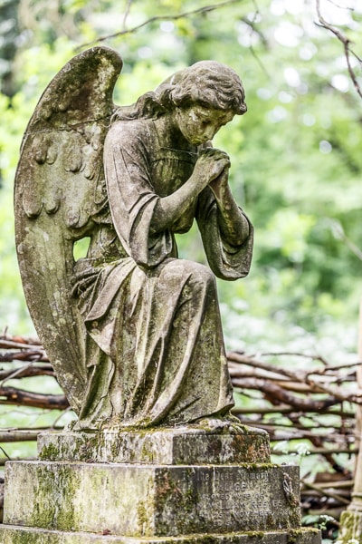 Mourning angel sculpture in a cemetery.