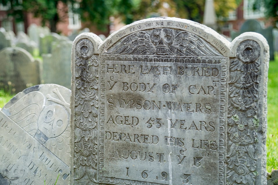 Close up of an old tombstone from 1693 in a Boston cemetery.