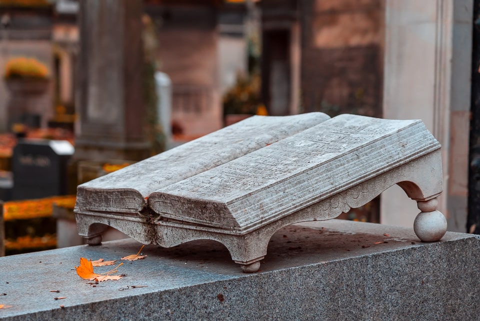 Stone book sculpture on a grave.