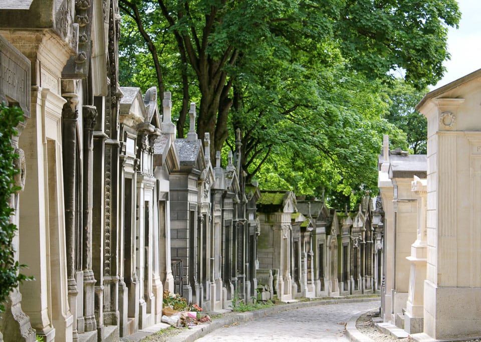 Small mausoleums lining a pathway.