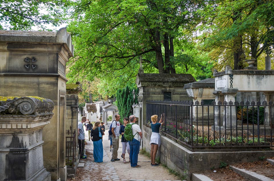 A group of tourists visiting Père Lachaise Cemetery.