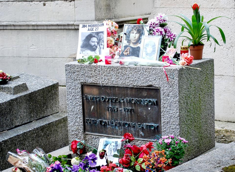 Flowers and photographs on the grave of Jim Morrison.