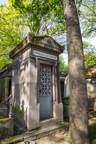 Family tomb building of Georges Seurat by a tree.