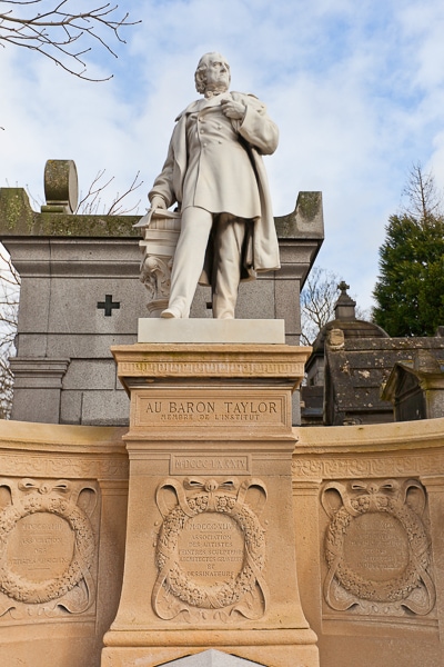 Statue on a pedestal above the grave of Baron Taylor.