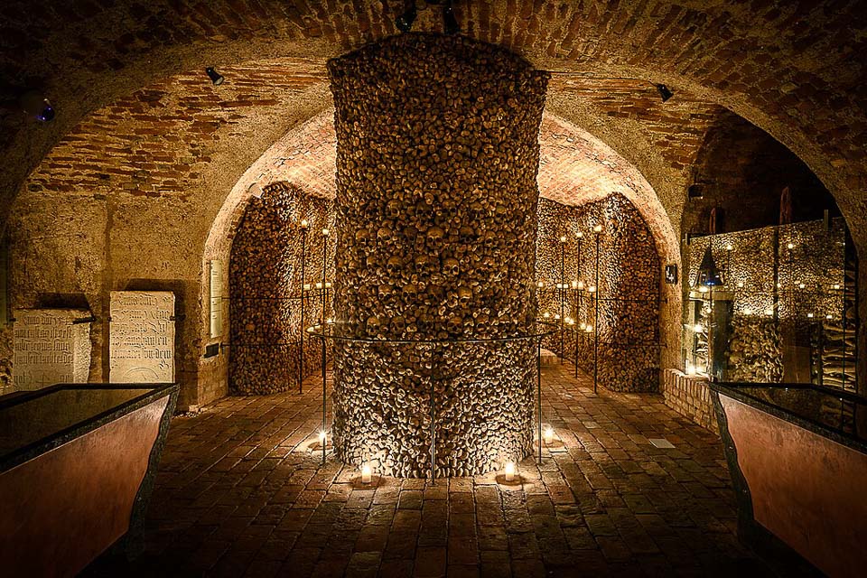 Column and wall of bones in a chamber of the Brno Ossuary.