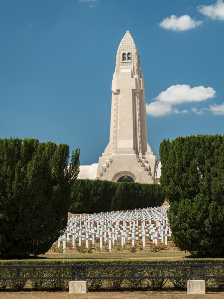 Exterior view of the tower with a field of white crosses in the cemetery.