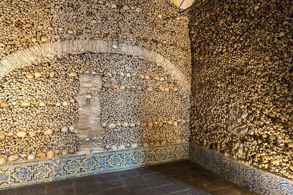 Rows and arches of bones on the wall.