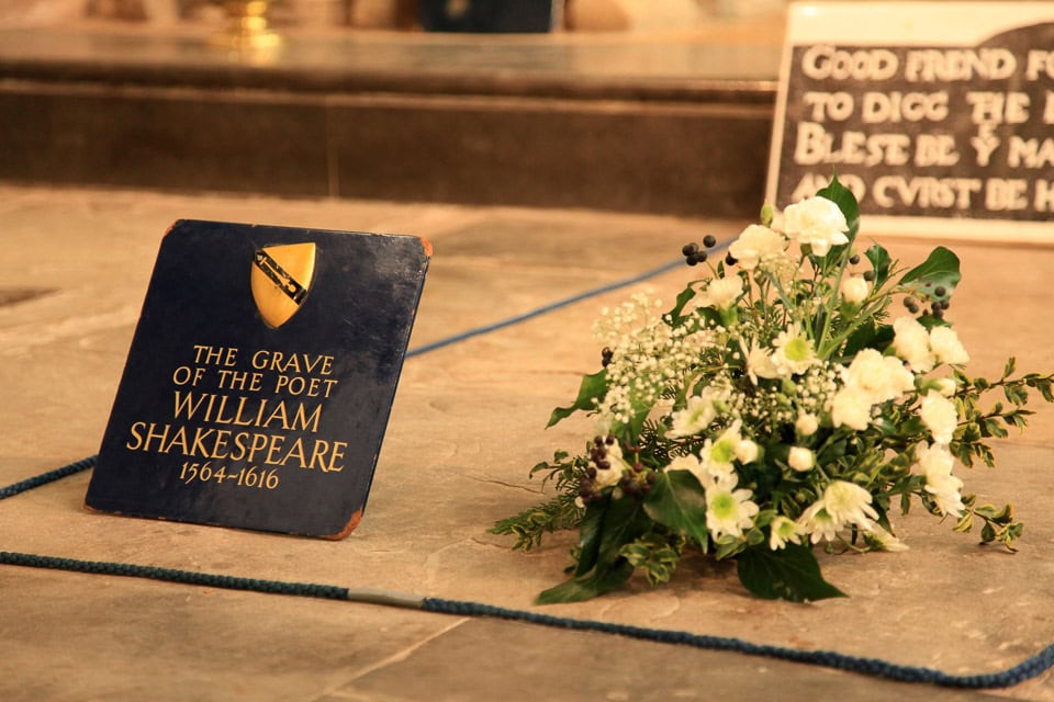 Flowers and plaque on the grave of William Shakespeare.