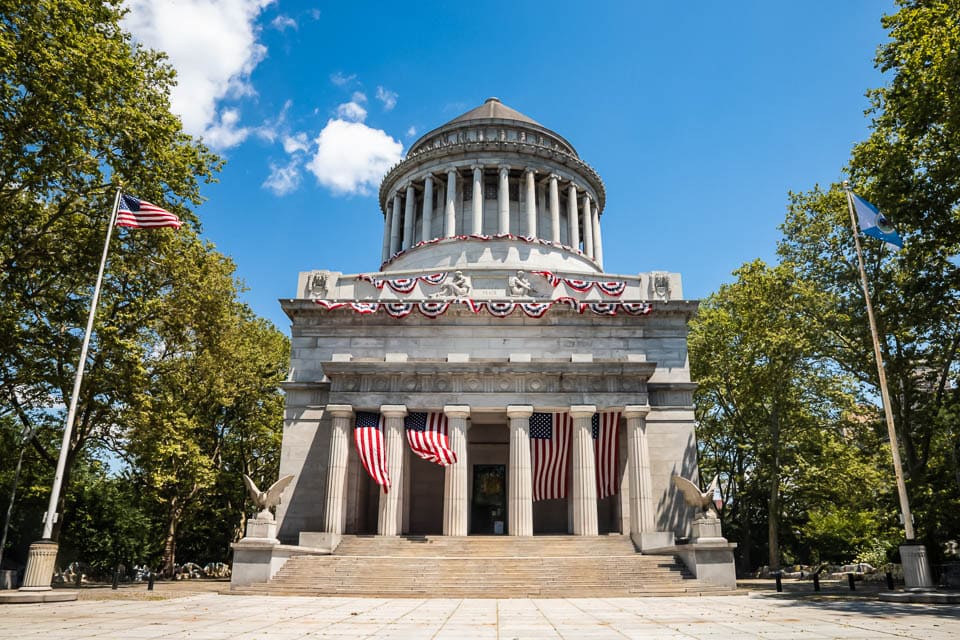 Exterior of the General Grant National Memorial decorated with American flags. 