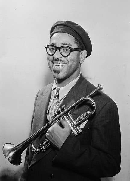 Black and white photo of Dizzy Gillespie holding a trumpet.